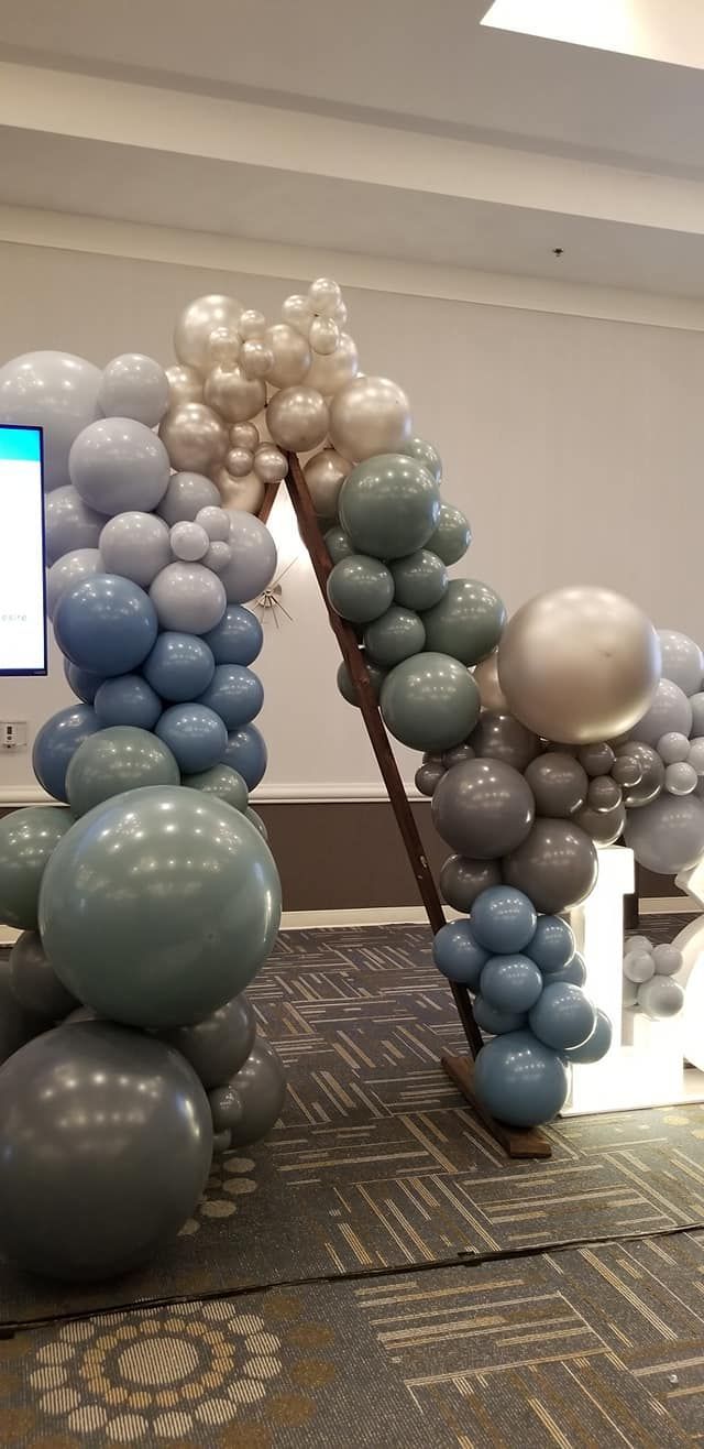 A bunch of balloons are stacked on top of each other in a room.