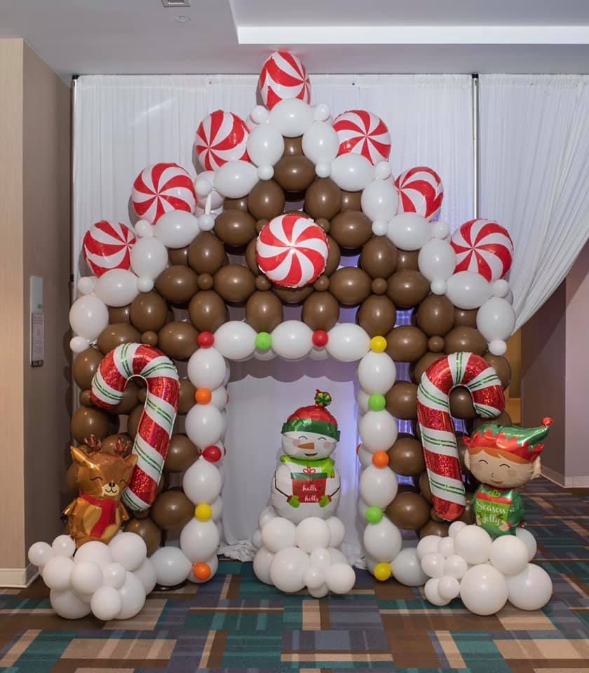 A gingerbread house made of balloons and candy canes