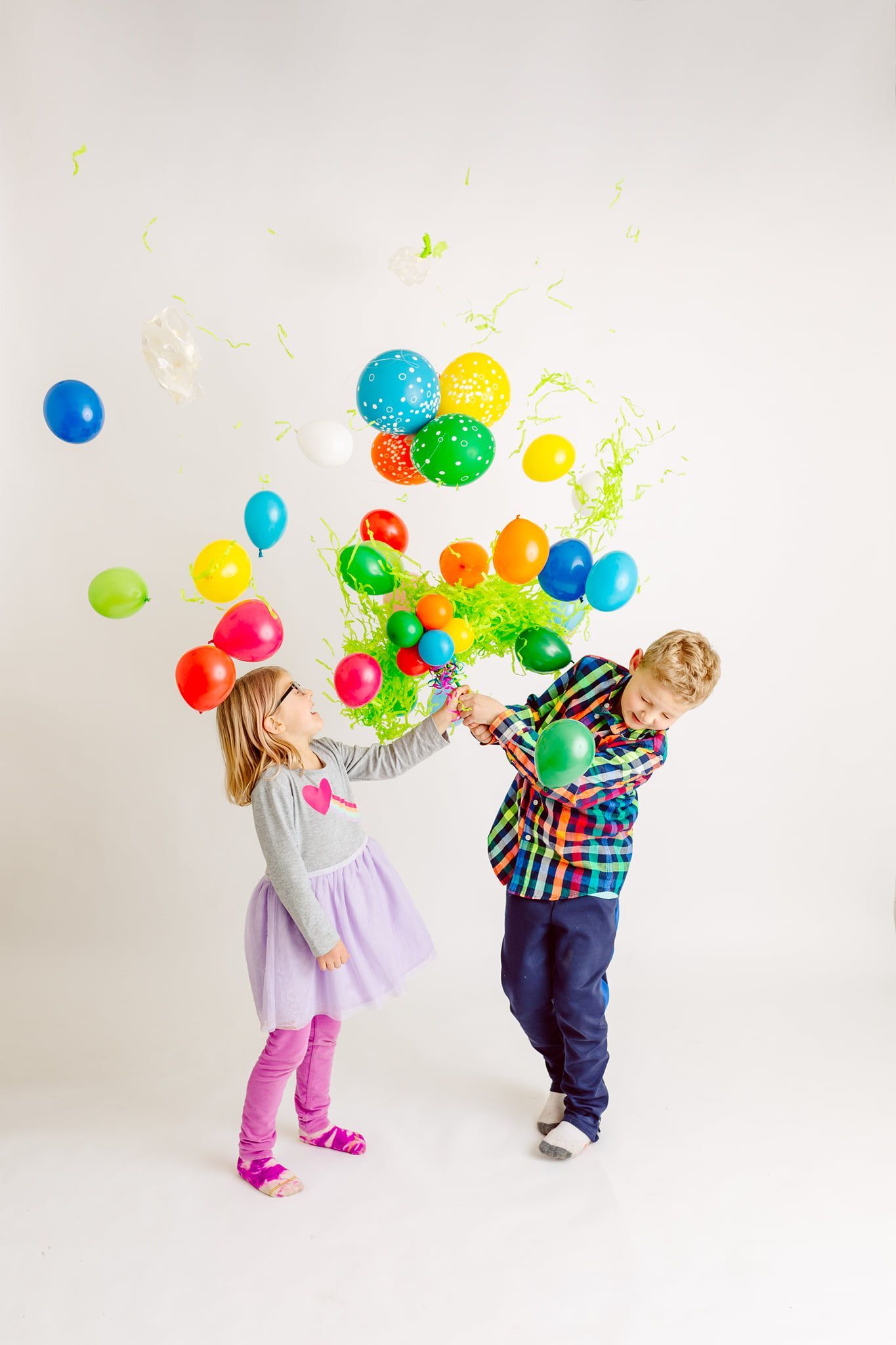 A boy and a girl are playing with balloons. Pop Drop