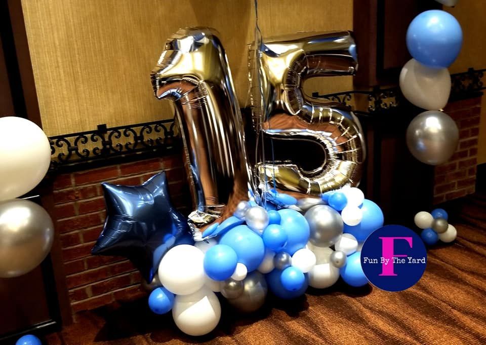 A bunch of blue and silver balloons with the number 15 on top. Balloon Marquee