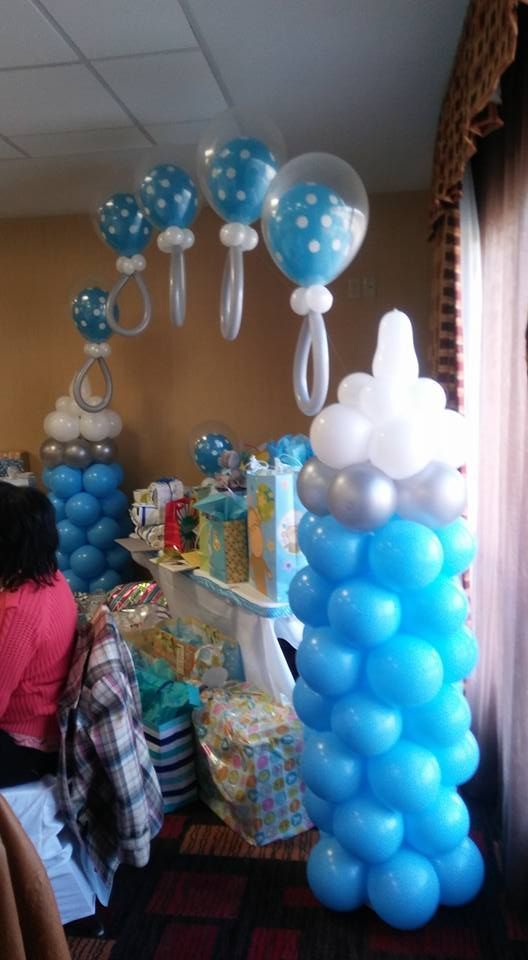 A room decorated with blue and white balloons for a baby shower.