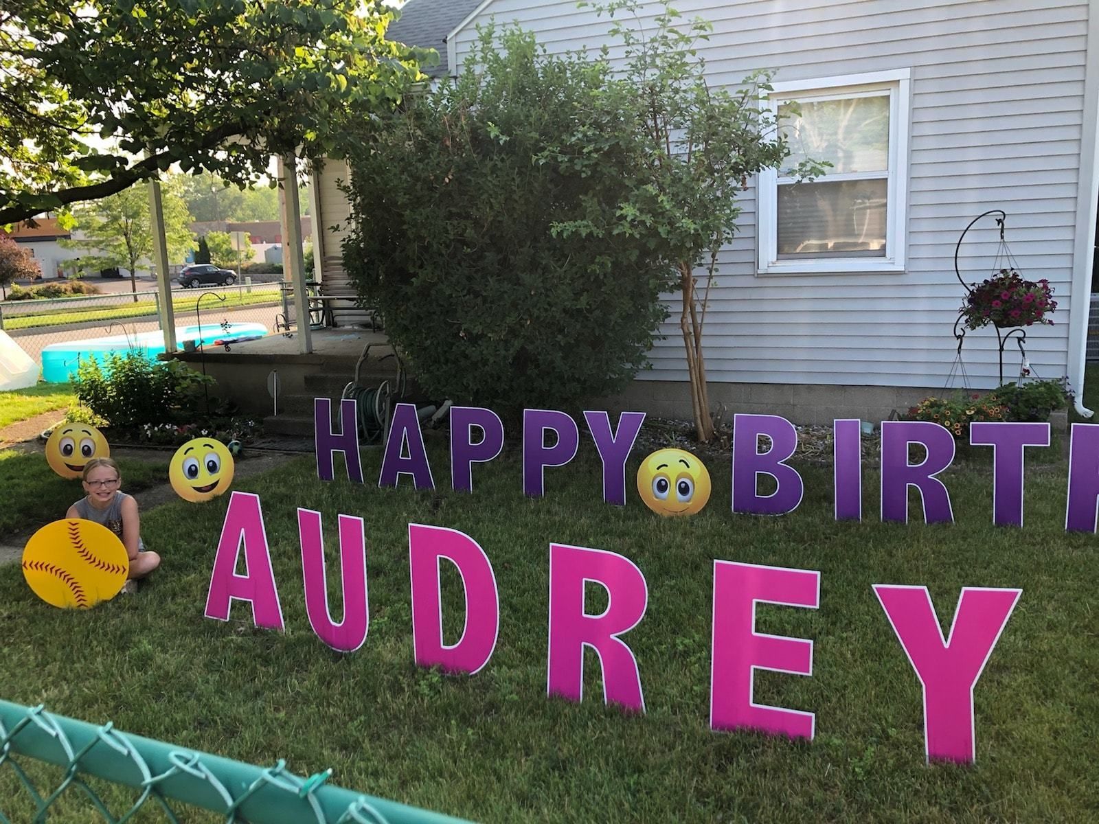 A happy birthday sign for audrey is in front of a house