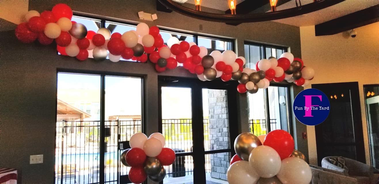 A bunch of balloons are hanging from the ceiling in a room.