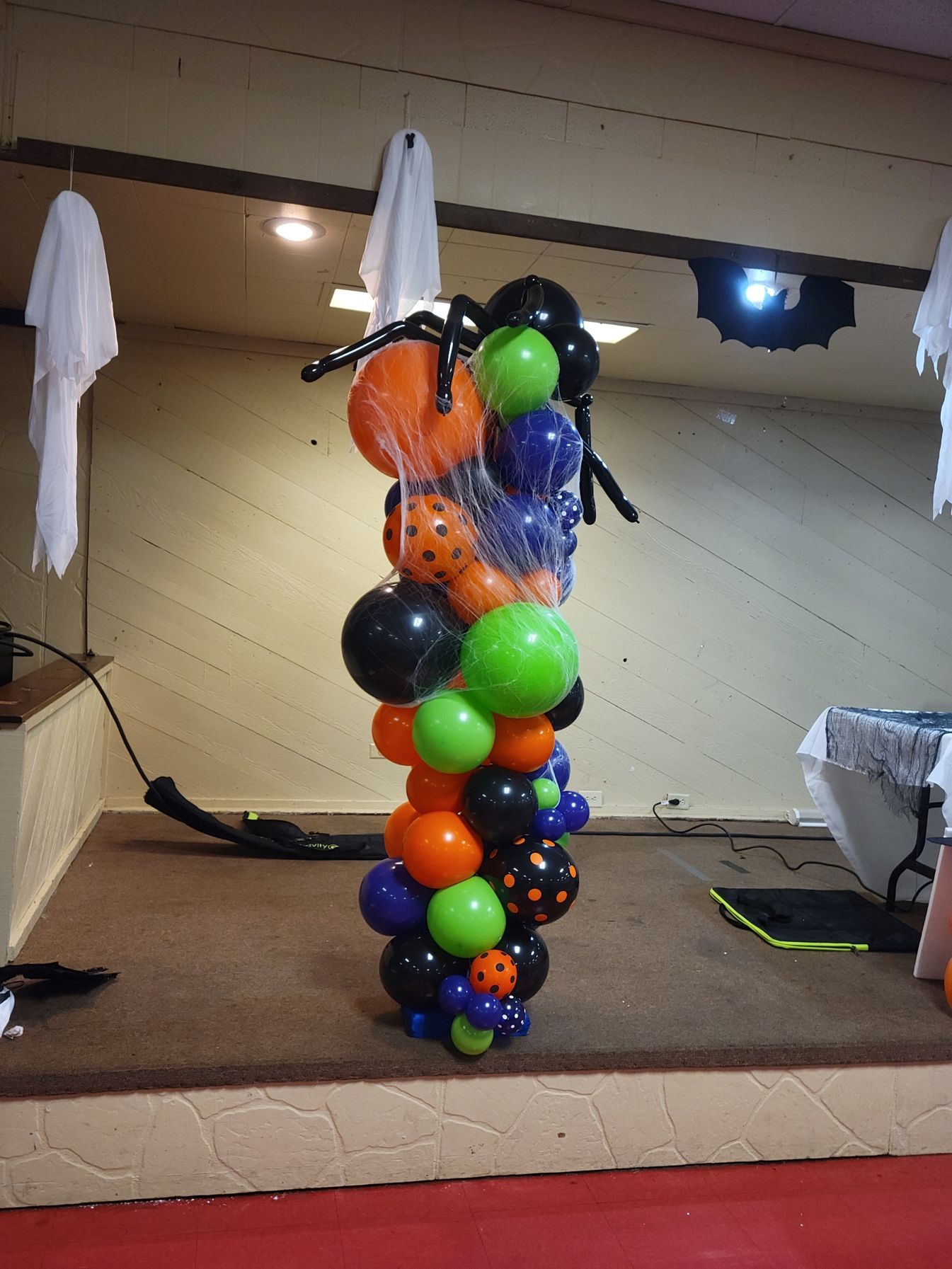 A bunch of halloween balloons are stacked on top of each other