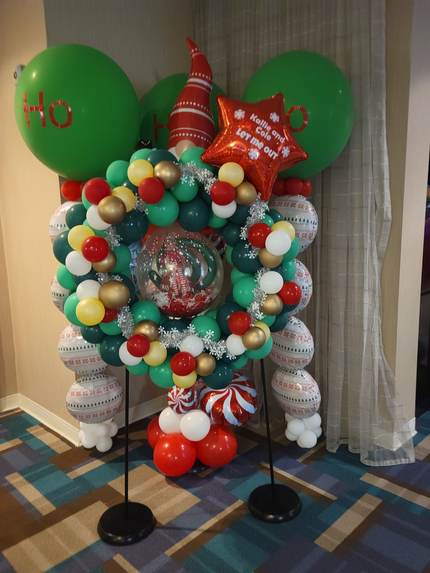 A christmas wreath made of balloons with the word ho on it