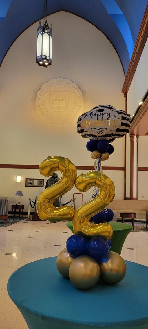 A table with balloons in the shape of the number 22 on it.