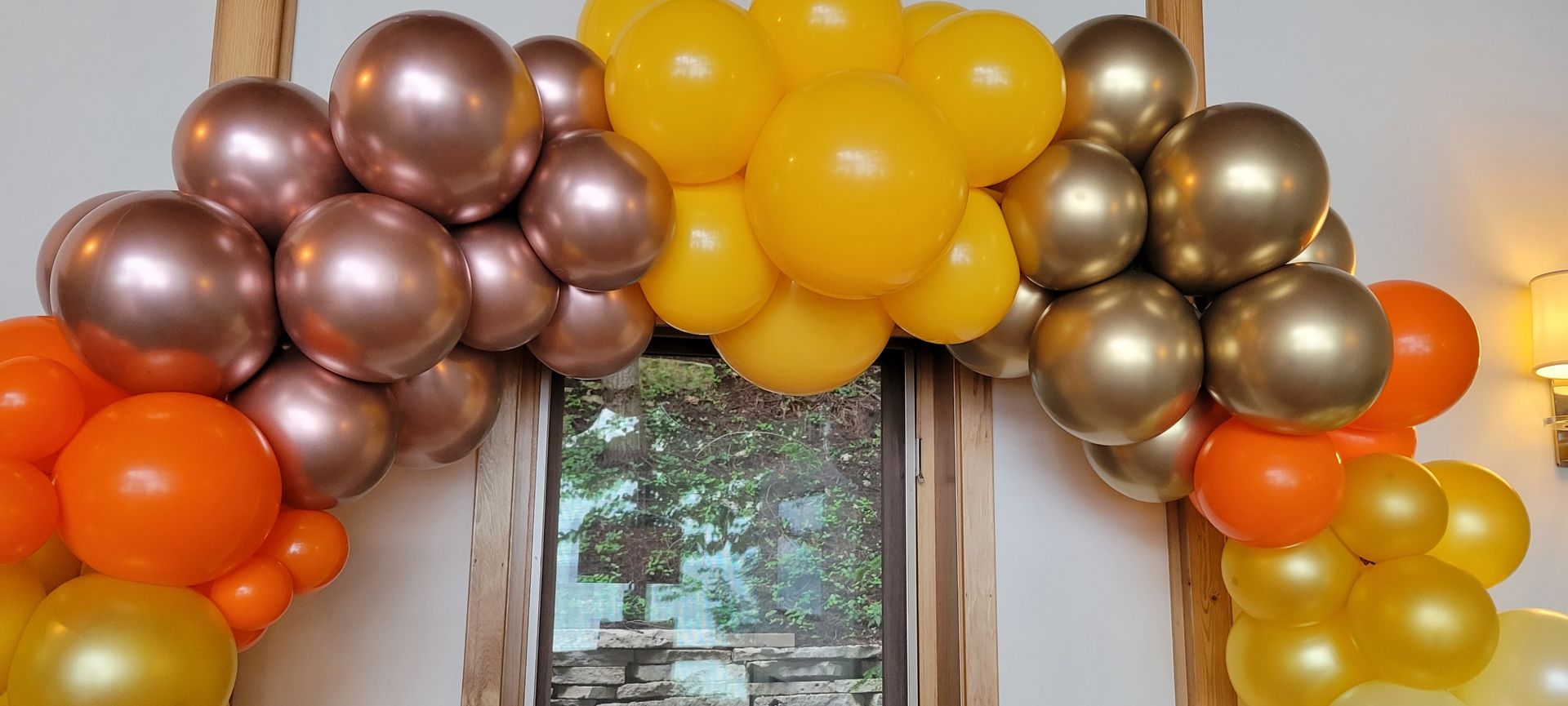 A bunch of balloons are hanging on a wall.