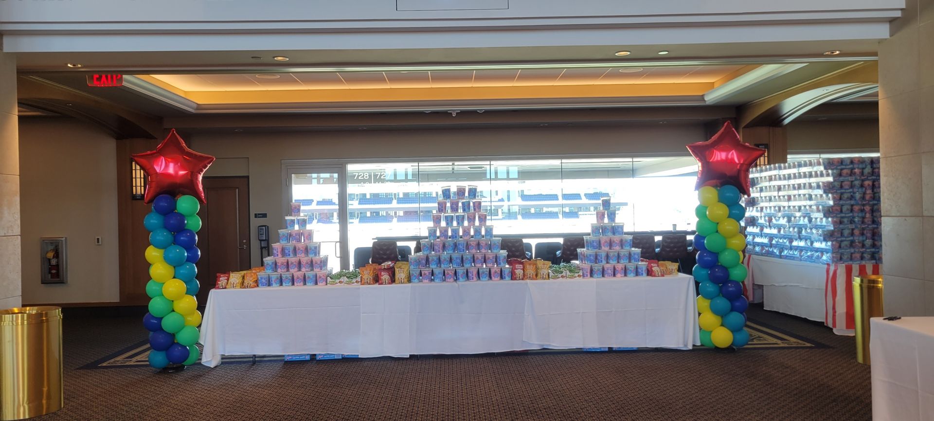 A room with a table and balloons in it