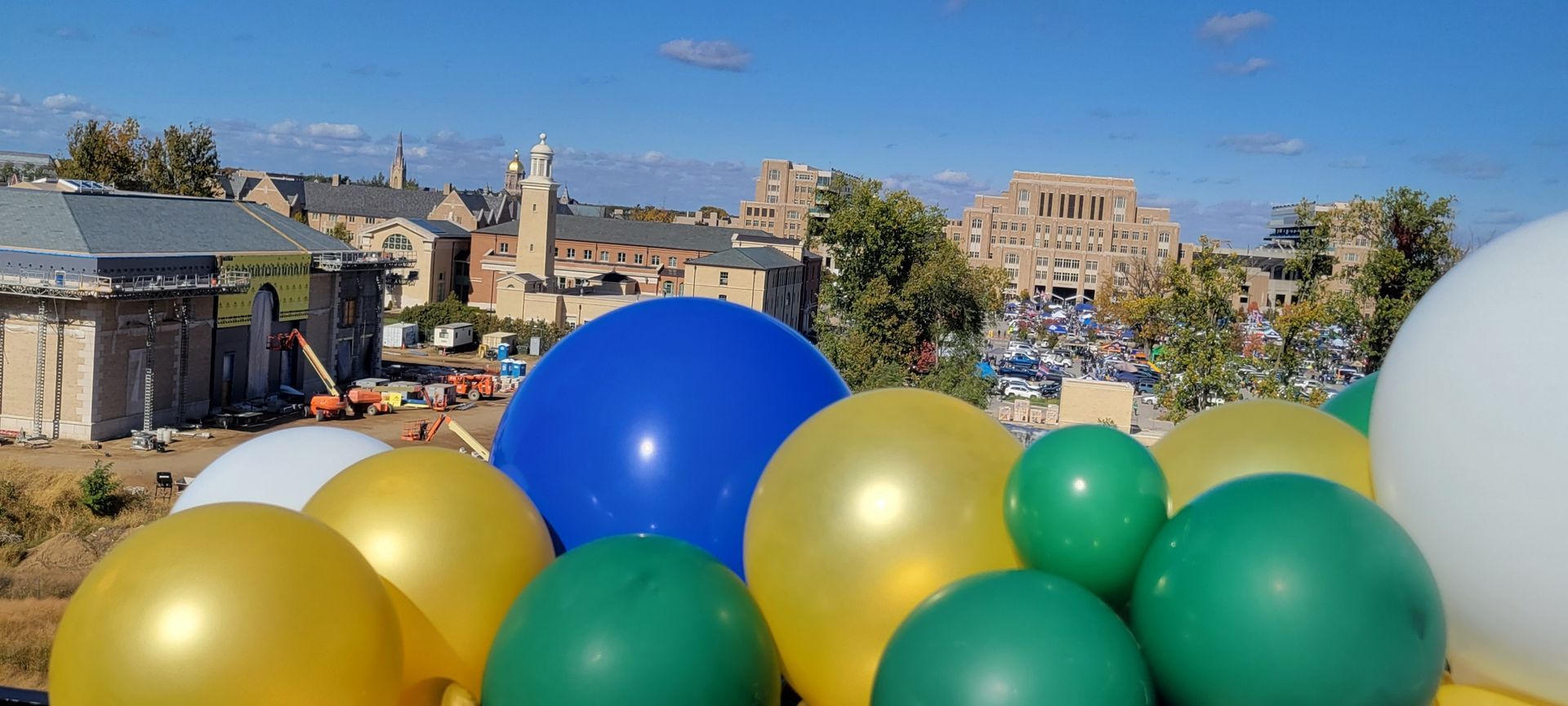 a bunch of balloons with a city in the background