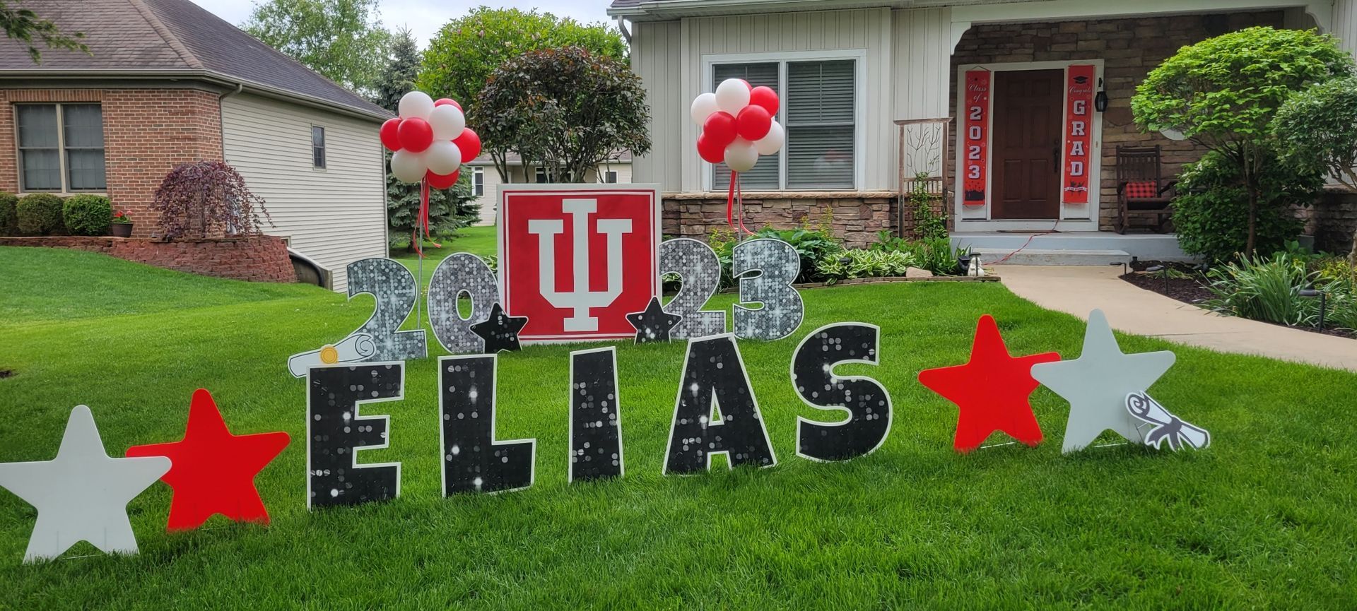 A yard sign for elias is in front of a house.