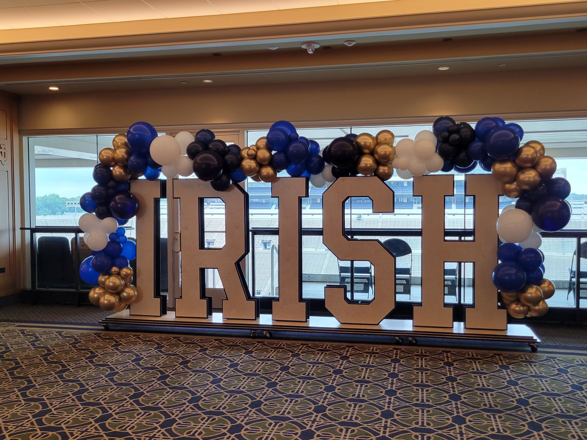 The word irish is surrounded by balloons in a room.