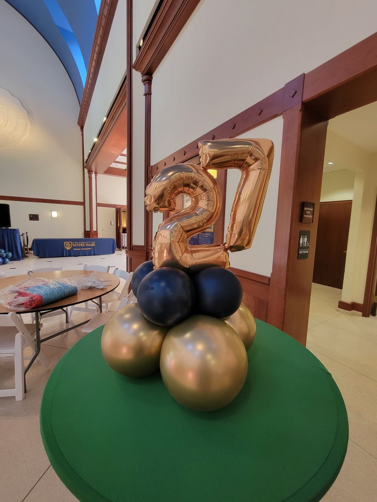 A number 27 balloon is sitting on top of a bunch of balloons