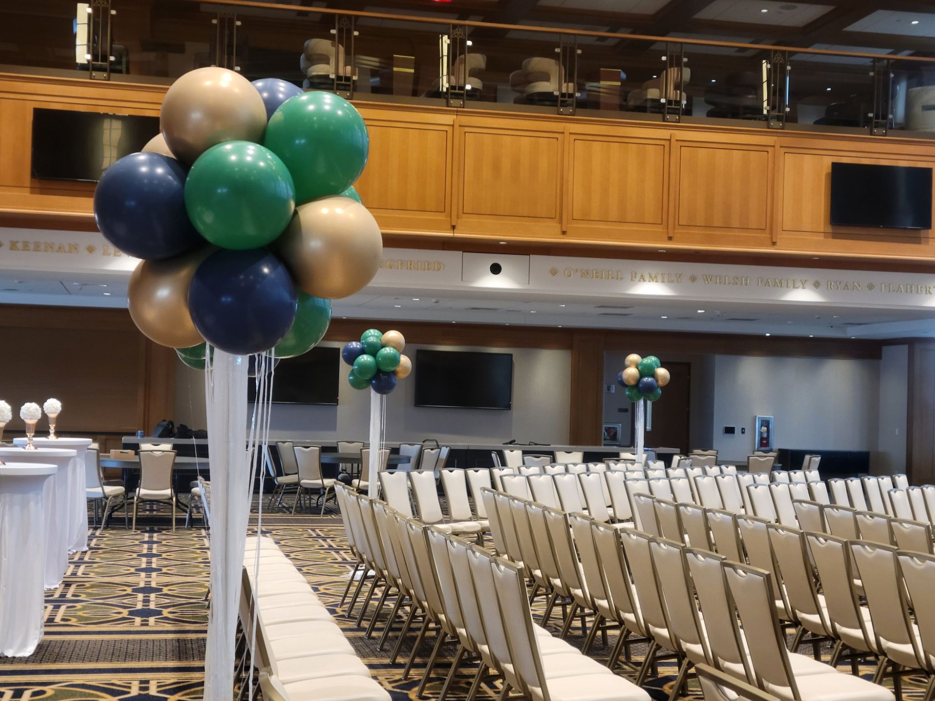 A large room with rows of chairs and balloons