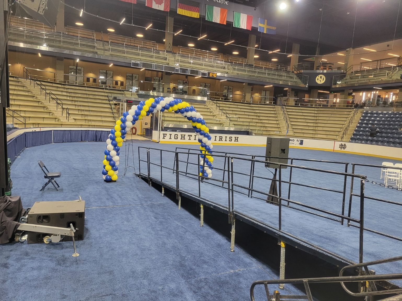 An empty stadium with a balloon arch in the middle