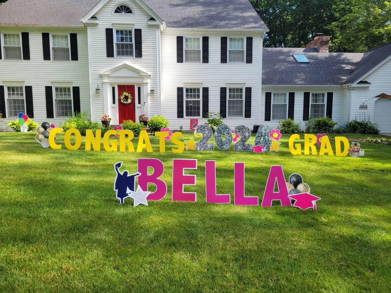 A house with a congratulations sign in front of it.