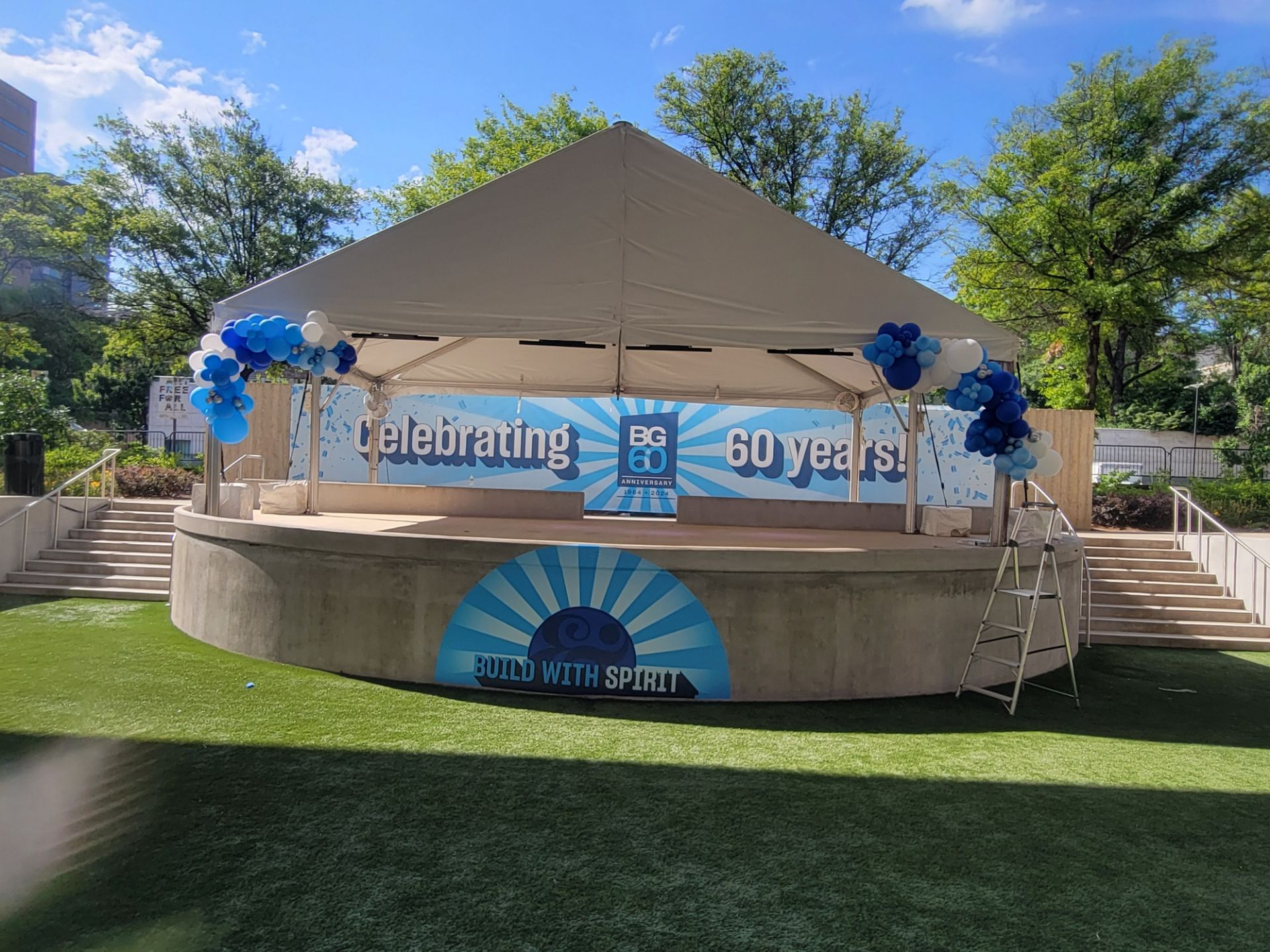 A stage with balloons and a sign that says celebrating 60 years