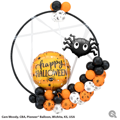 A happy halloween balloon with a spider on it