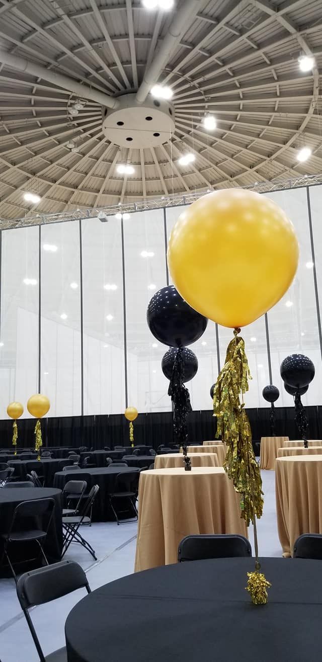 A large yellow balloon is sitting on top of a table in a room.