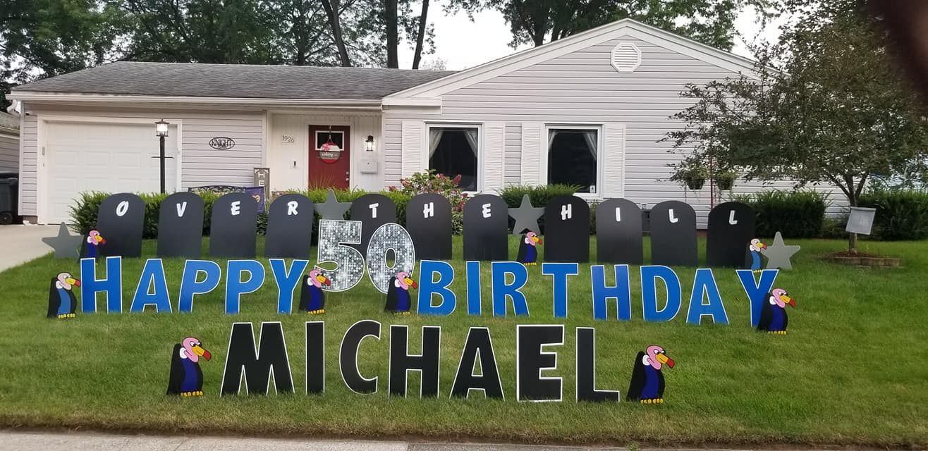 A happy birthday sign for michael is in front of a house.