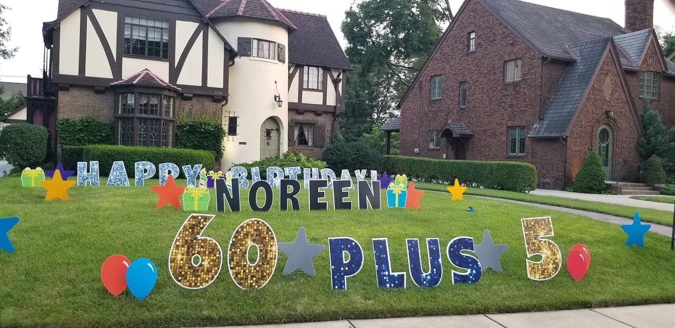 A happy 60th birthday sign is in front of a house.