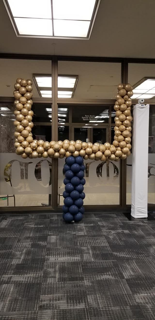 A football goal post made out of balloons in a room.