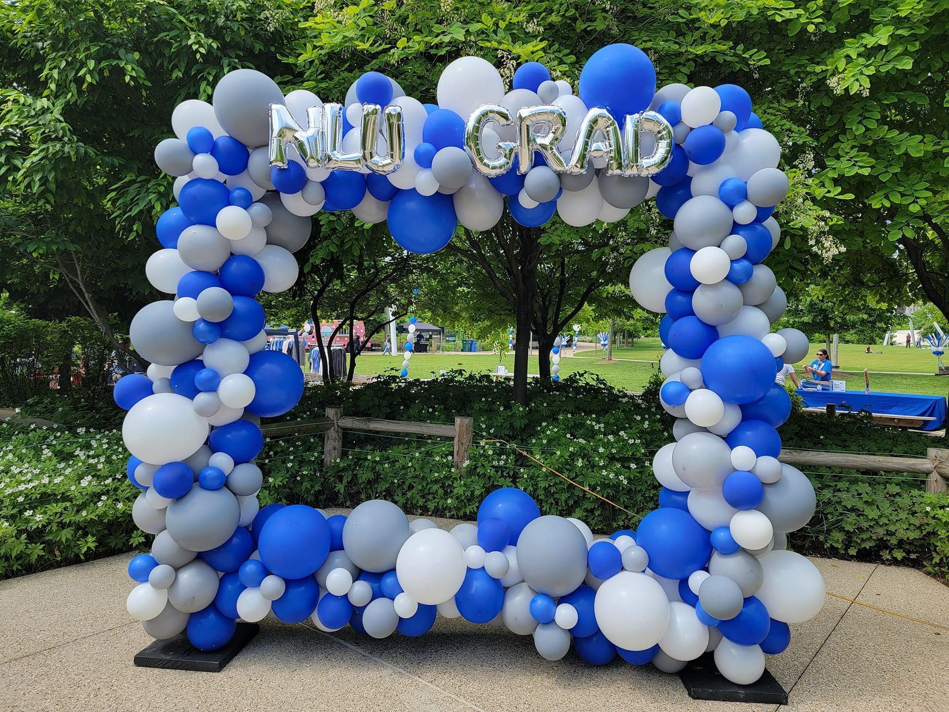 A picture frame made of blue , white and gray balloons