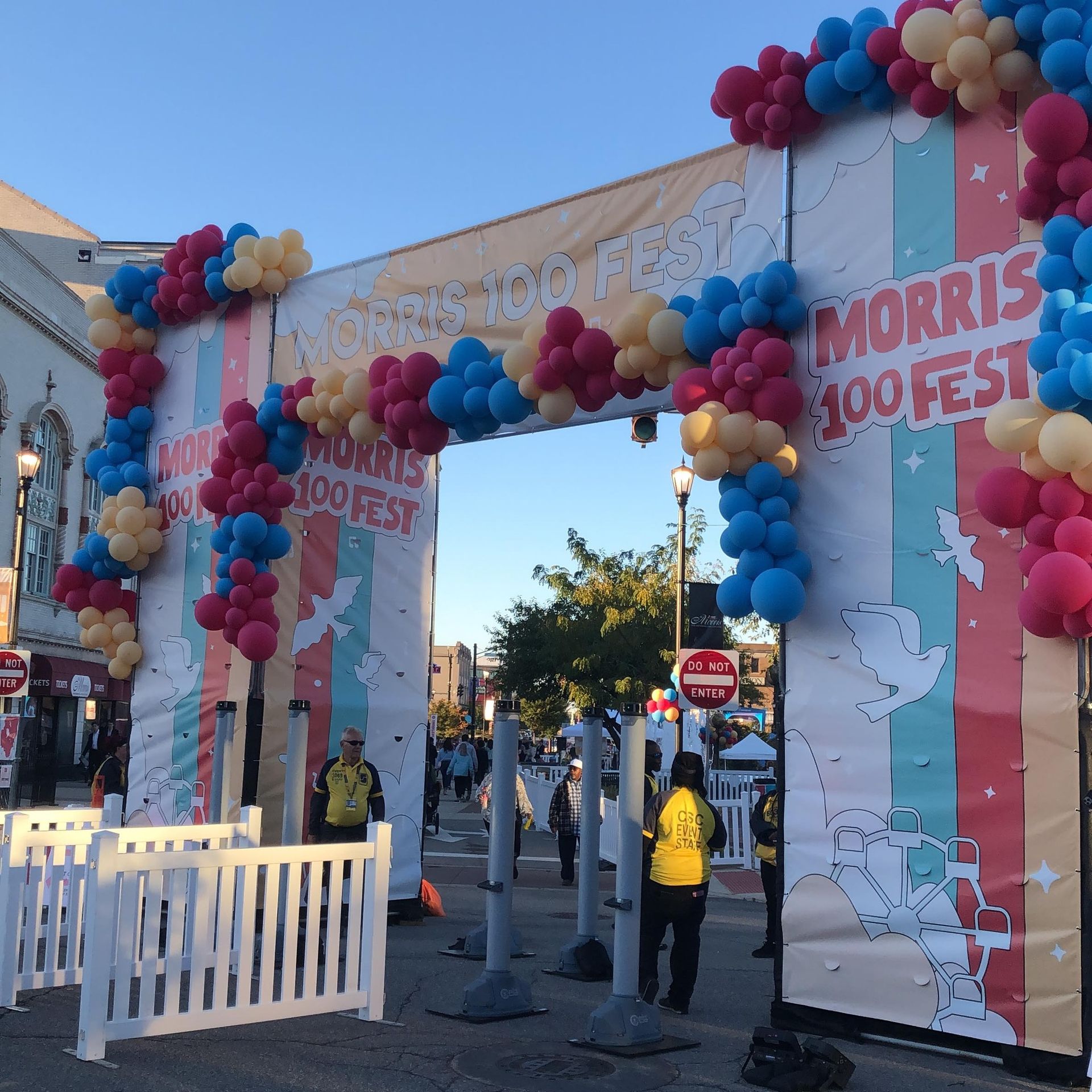 A sign that says morris 100 fest is decorated with balloons from Fun By The Yard