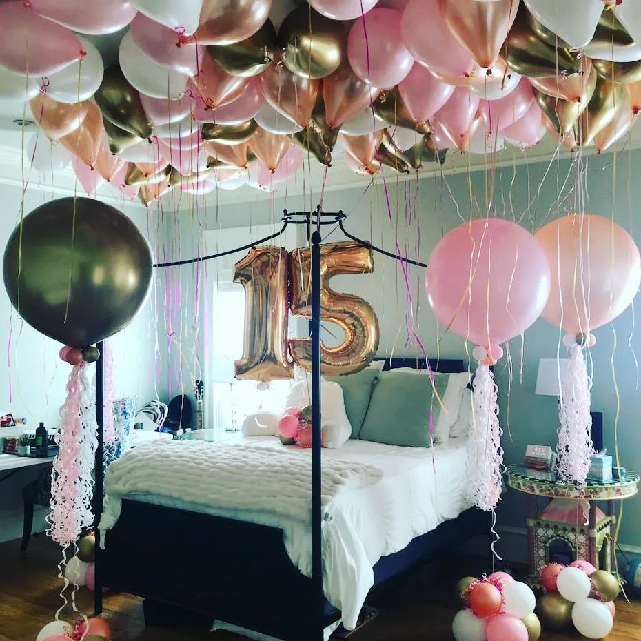 A bedroom decorated with balloons and a number 15 balloon.  Party Bomb