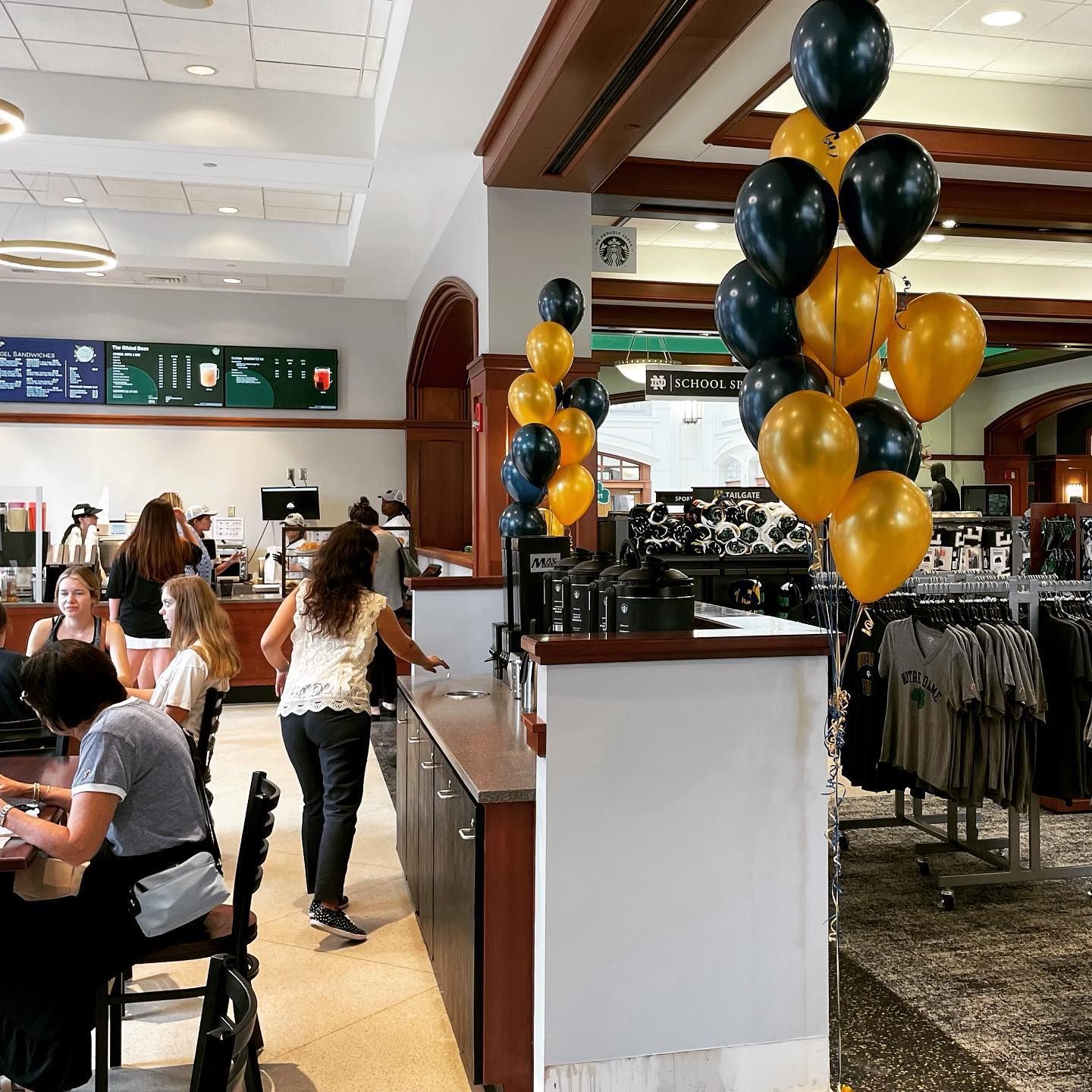 a restaurant with a bunch of balloons hanging from the ceiling