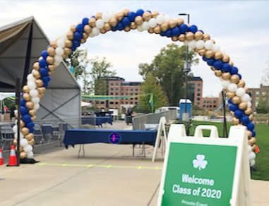 There is a sign that says welcome class of 2020 on it.  Balloon Arch