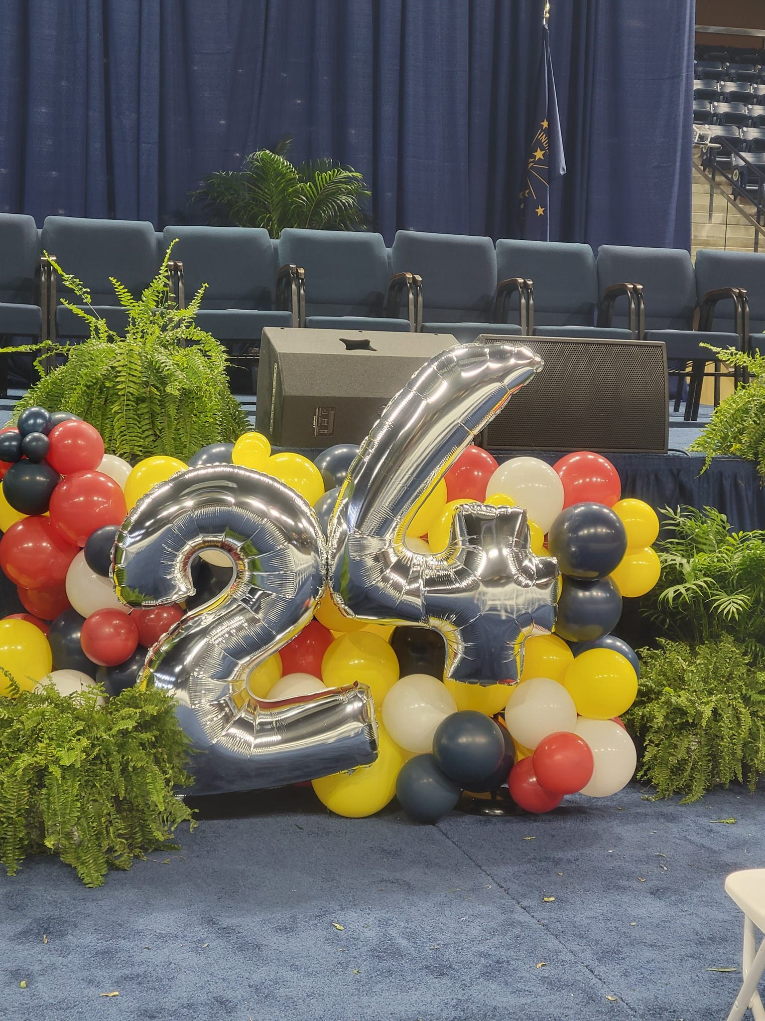 A bunch of balloons with the number 24 on them
