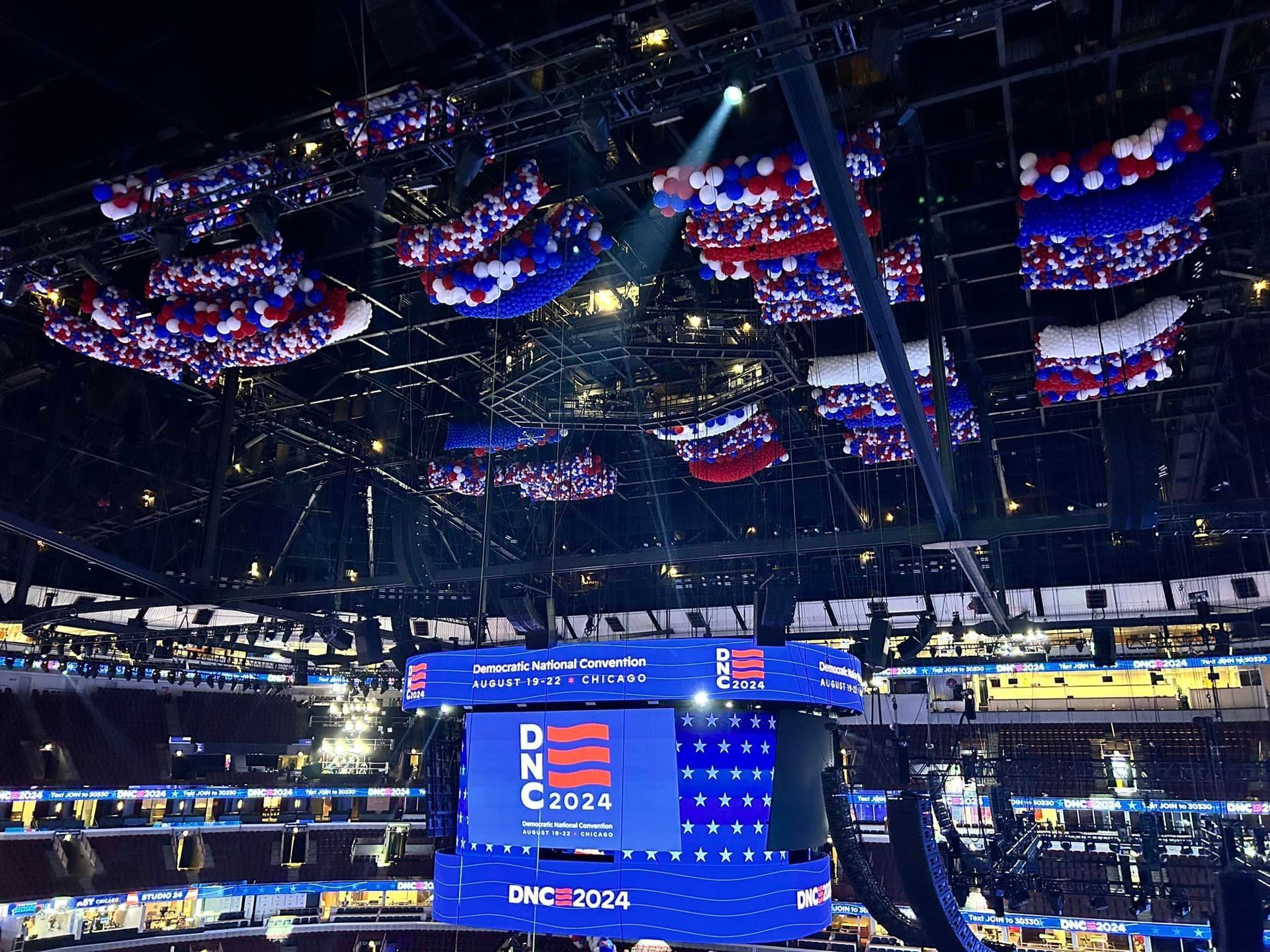 A large screen in a stadium says dnc 2024.  Balloon Drop
