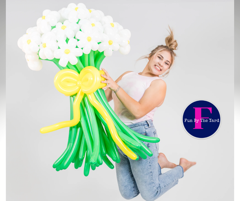 A woman is holding a bouquet of balloons that look like flowers