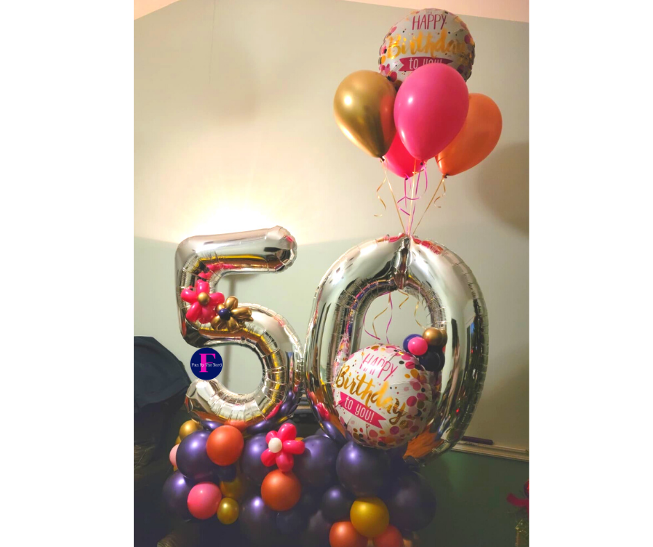 A bunch of balloons with the number 50 on them. Balloon Marquee