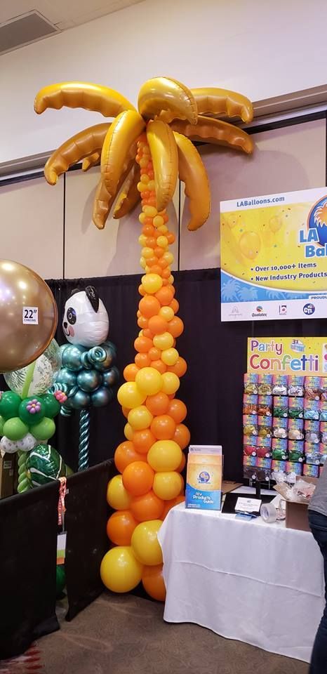 A palm tree made out of balloons in a room.