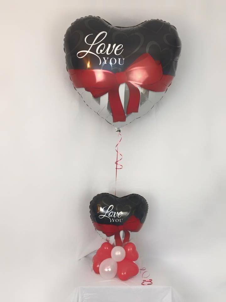 A heart shaped balloon with the words love you on it