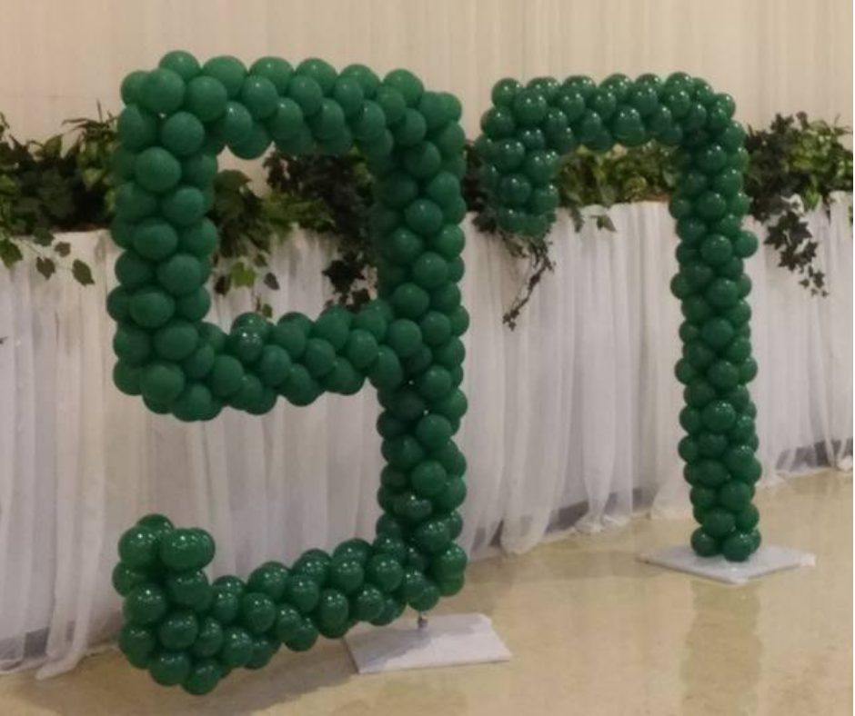 Green balloons are arranged in the shape of the letter n