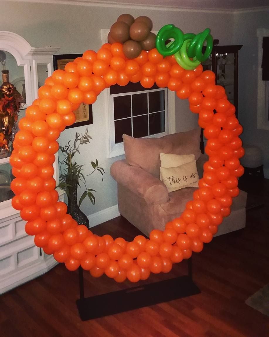 A wreath made of orange balloons in a living room