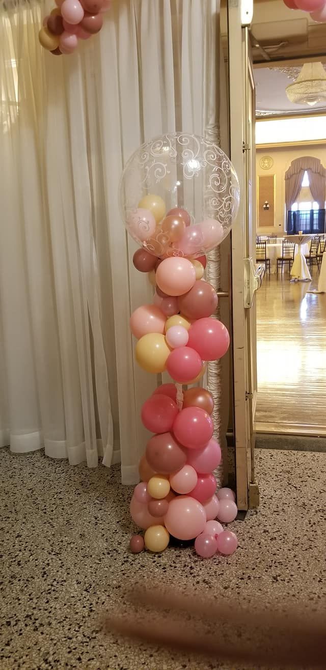 A bunch of balloons are stacked on top of each other in a room.