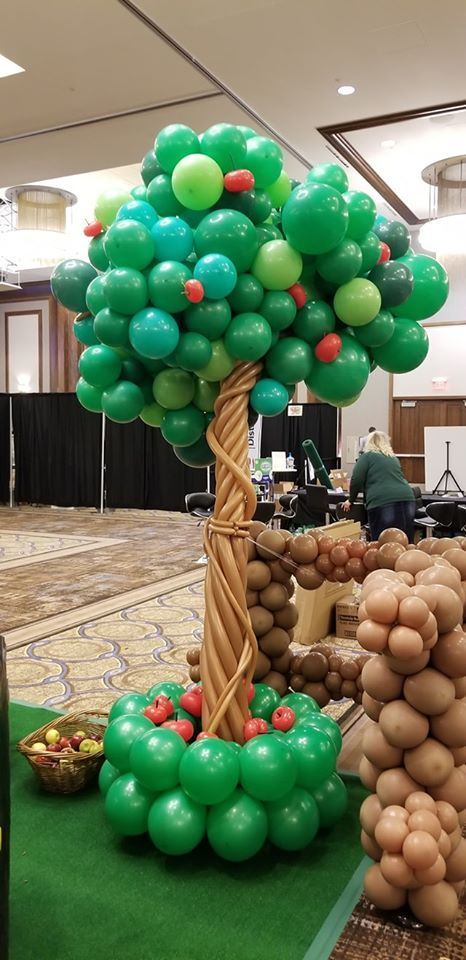 A tree made out of balloons in a room.