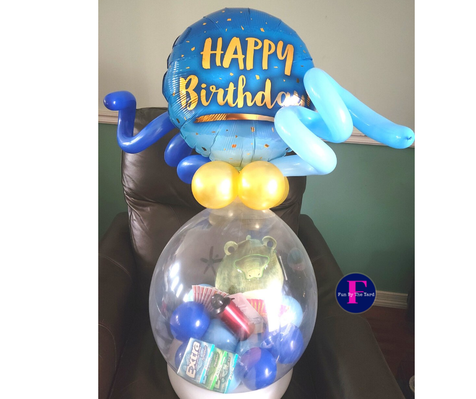 A stuffed balloon that says happy birthday on it