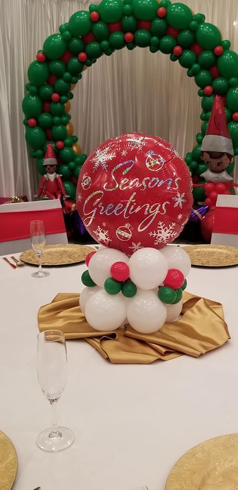 A christmas balloon centerpiece is sitting on top of a table.