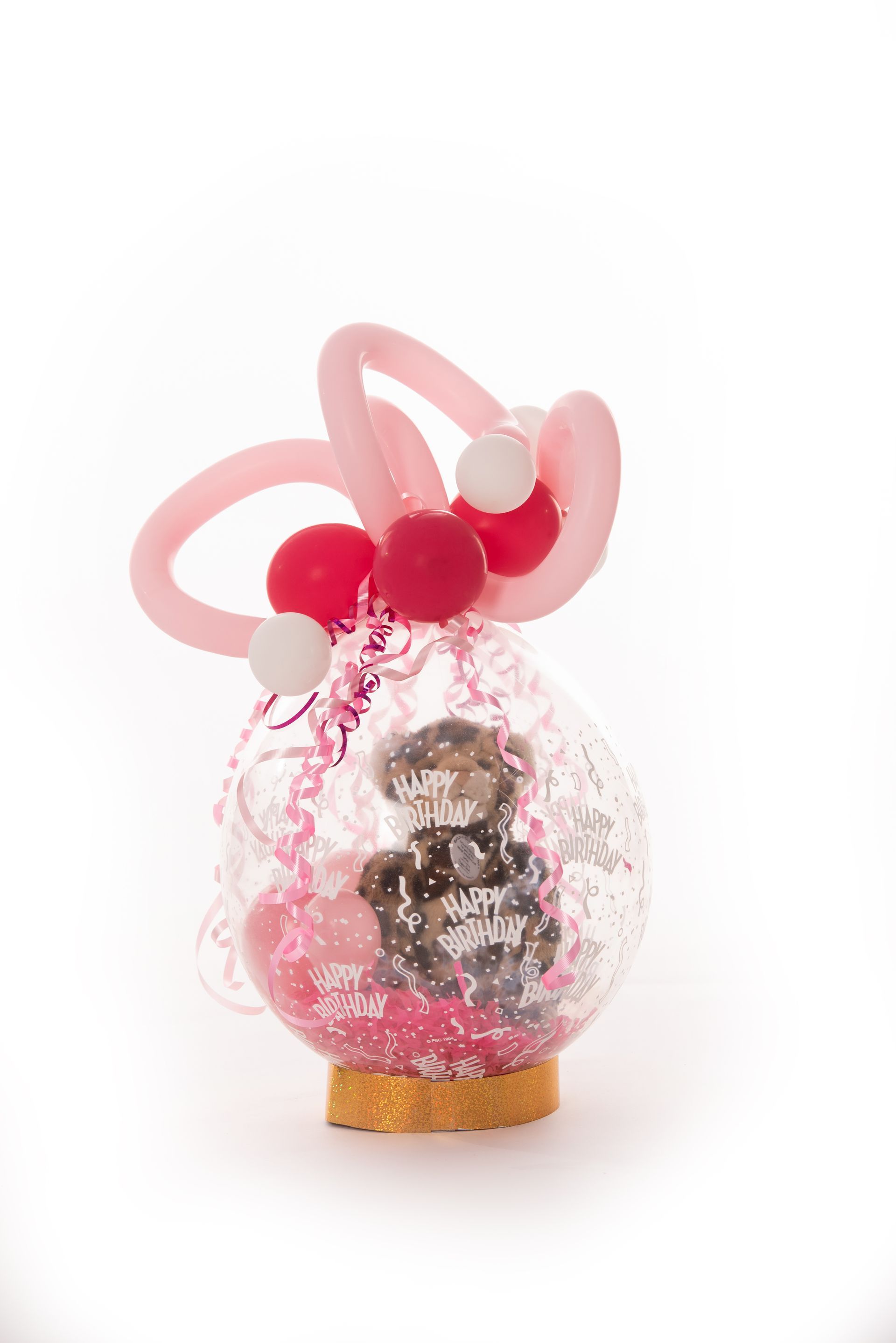 A teddy bear is wrapped in a balloon with balloons.