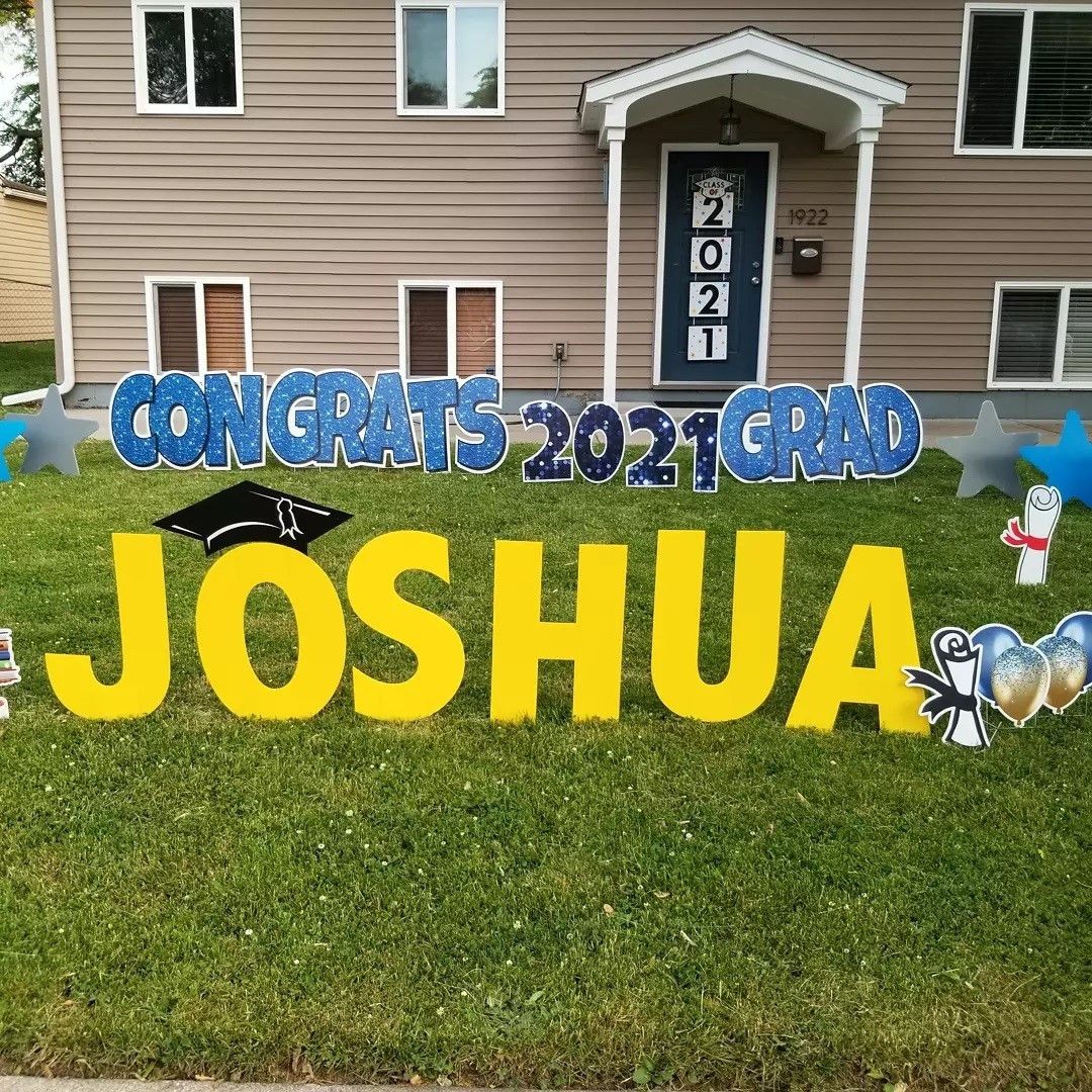 A congratulations sign for joshua is in front of a house.