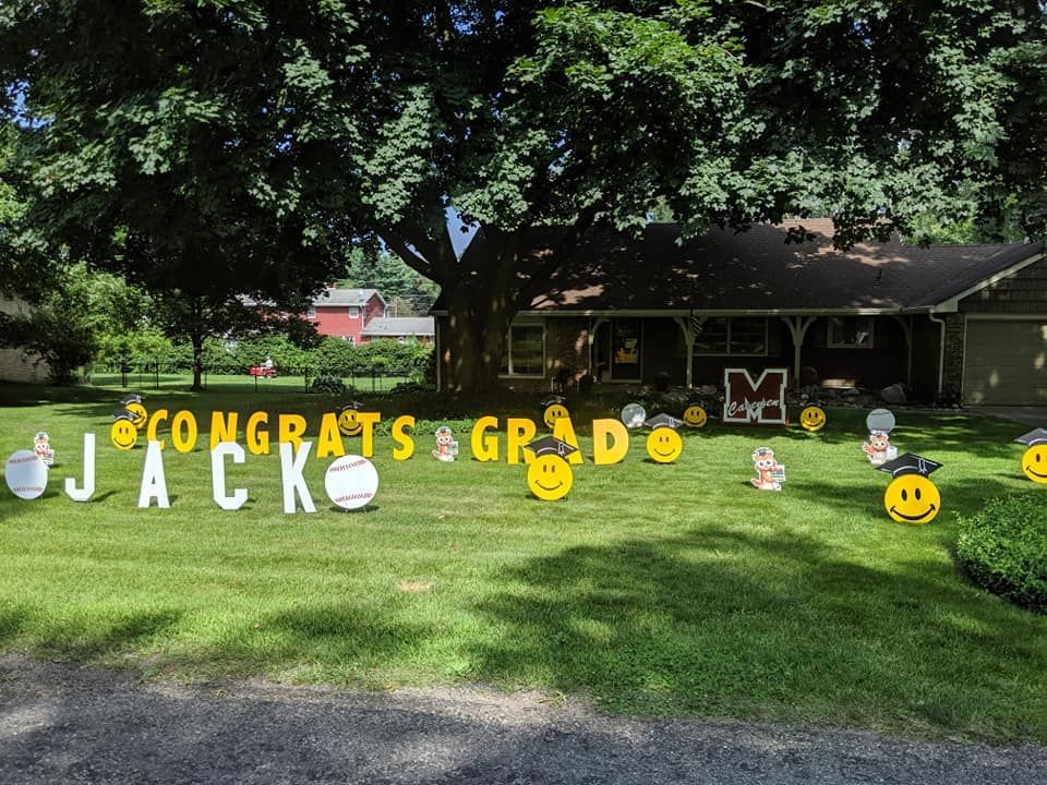 A lawn with a sign that says congrats jack on it