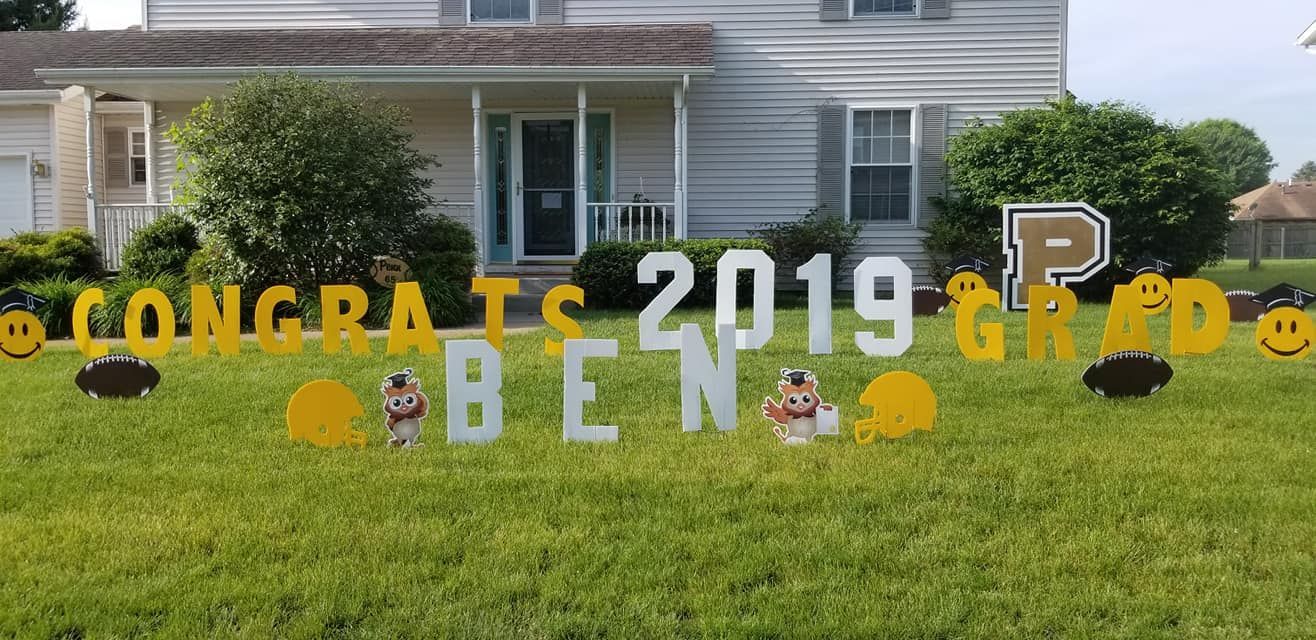 A yard sign that says `` congrats 2019 ben '' is in front of a house.