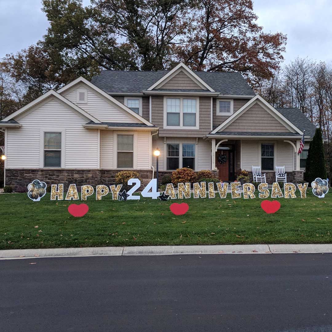 A house with a happy 24th anniversary sign in front of it.