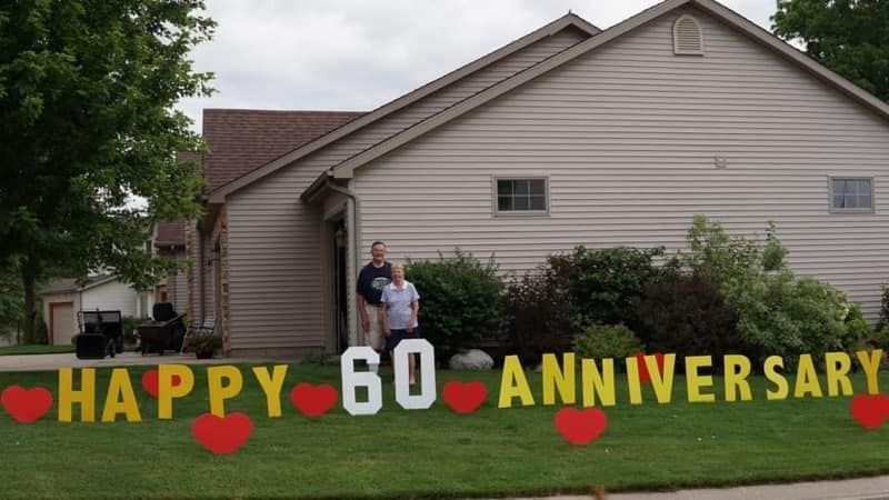 A happy 60th anniversary sign is in front of a house