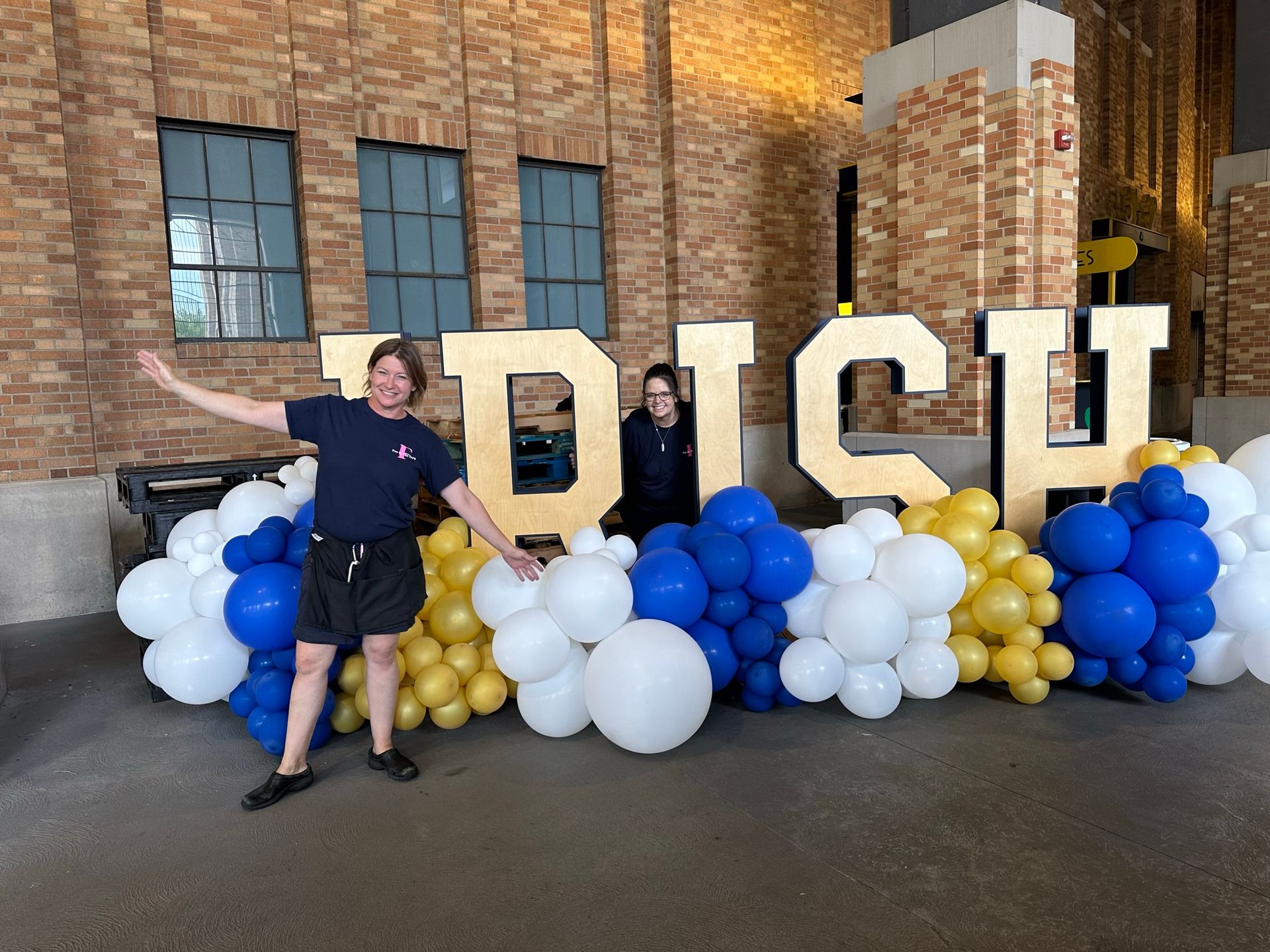 Wooden letters spelling Irish with blue white and gold balloon garland at Notre Dame Stadium
