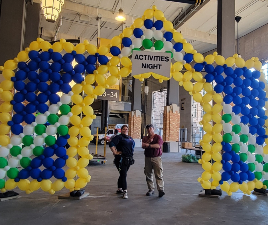two people standing under a sign that says activities night